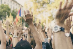 crowd with hands in the air, photo by Chris Slupski