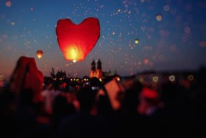 heart-shaped lanterns rising into the night sky, photo by Erik Witsoe