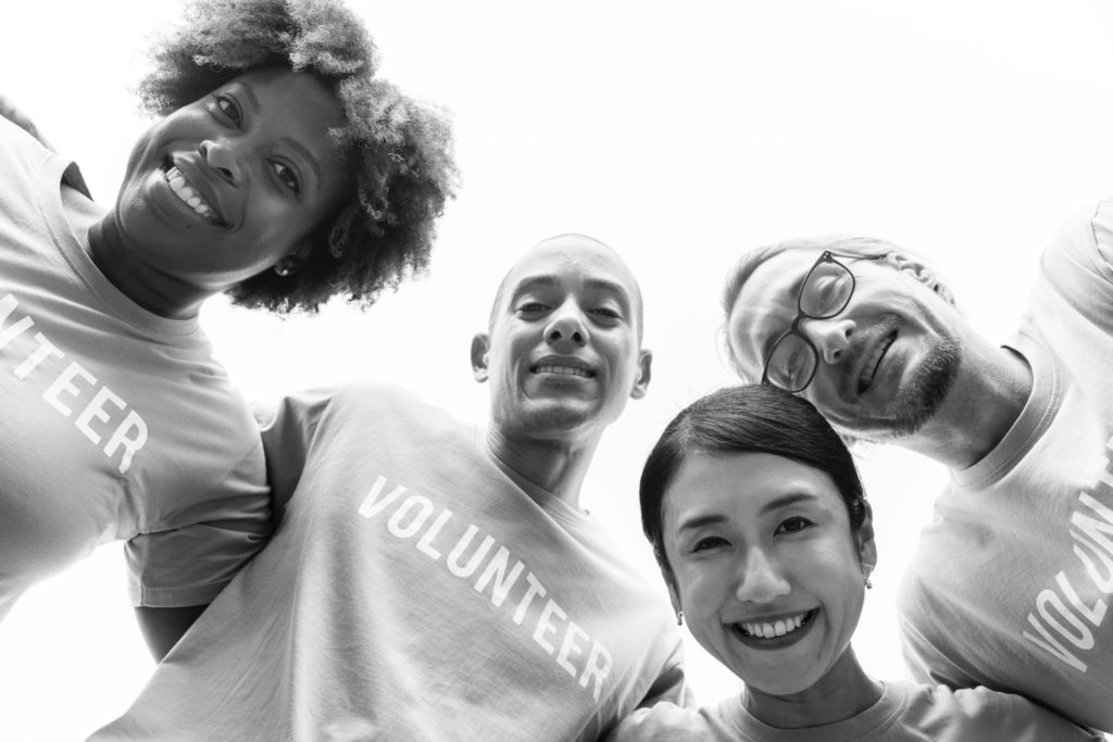 group of people wearing Volunteer t-shirts, photo by rawpixel